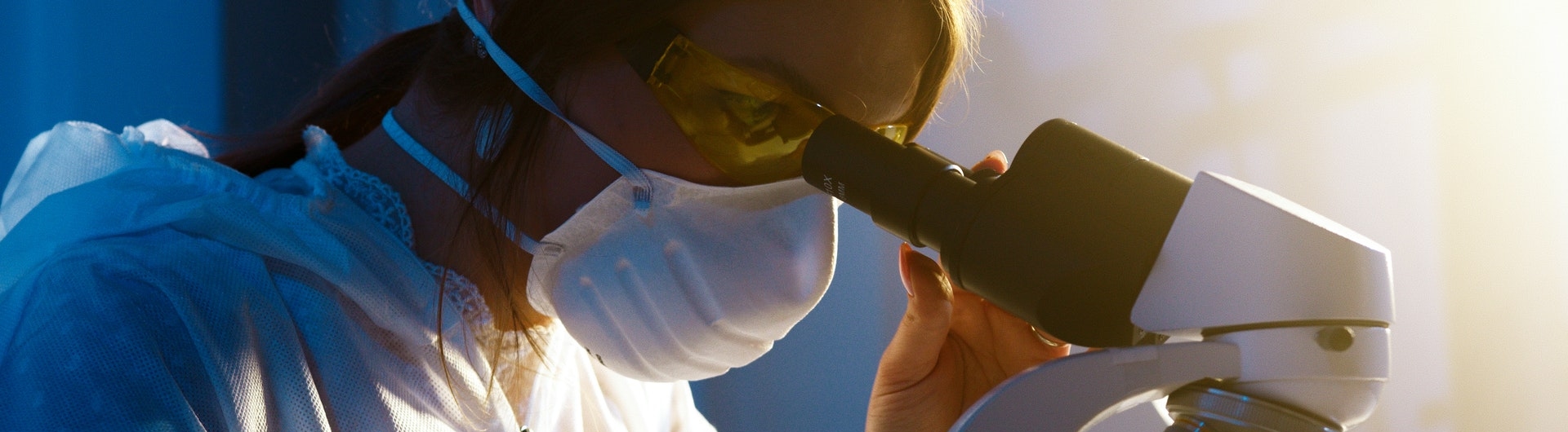 Mujer mirando un microscopio